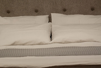 cozy bed with pillows for sleeping and rest