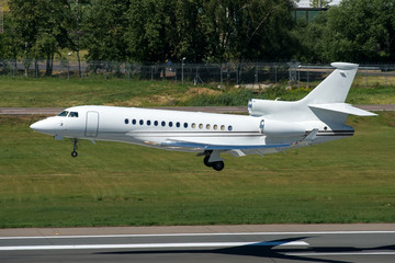 White modern private jet landing at airport