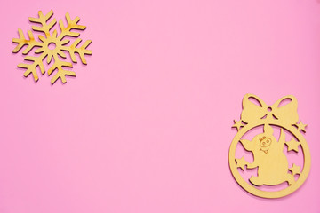 christmas wooden chinese pig and snowflake on pink background. New year 2019 greeting card with empty space for image or text