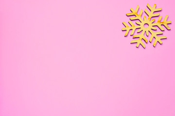 Obraz na płótnie Canvas Wooden beautiful snowflake for christmas decoration on pink background. New year 2019 greeting card with empty space for image or text.