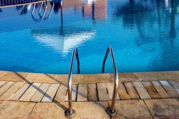 Swimming Pool with Blue Water and Steel Ladder