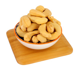 Bowl of roasted cashew nuts isolated on a white background