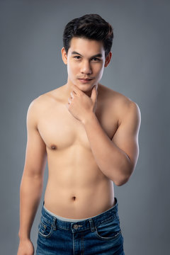 Portrait of shirtless young handsome Asian man studio shot