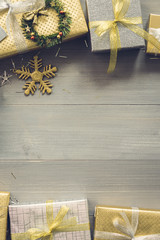 Shiny Christmas gift boxes on wood background top view border design