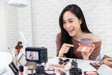 Pretty asian Blogger making a demonstration video about cosmetics and makeup.