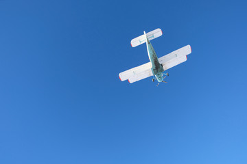 Biplane is in the blue sky.