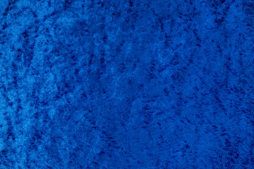 Dark blue shiny even velvet fabric as a background