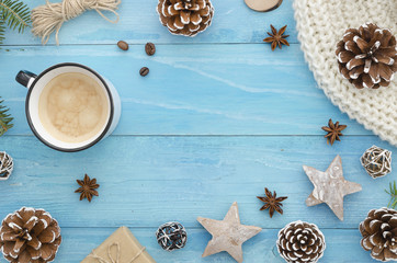 Christmas frame. Rustic blue wooden planks with anise star, pine cones and morning coffee. Winter,new year,Xmas Holiday seasonal greetings card. Trendy flat lay top view