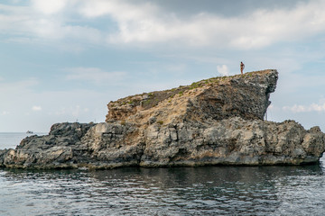 Fototapeta na wymiar Bikini girl on the rock in Malta