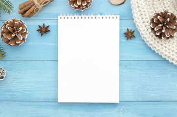 Blank notebook mock up. Christmas, winter,new year,Xmas - top view background. Rustic blue wooden planks with anise star, pine cones Holiday seasonal greetings card. Trendy flat lay design