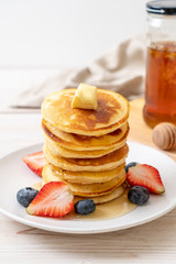 pancake with strawberries, blueberries and honey