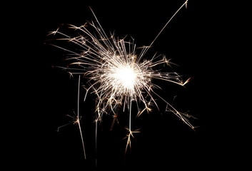 Ignited sparkler isolated on black background with clipping path