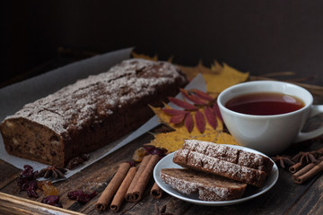 Homemade banana bread with anis star and cinnamon on a dark wooden background