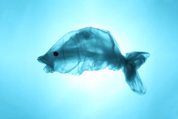 Plastic bags and garbage in the sea and ocean. Suffering sea animals. Fish symbol out of waste.