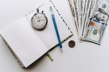 Time for quick money. Dollars, notebook, pen, clock. Usurer, credit, deposit concept.