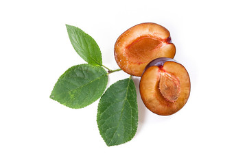 Half of ripe plum with leaf isolated on a white background..