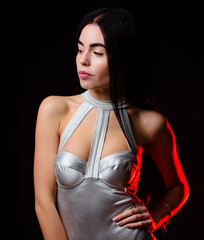 Lady wear sexy spaceship uniform black background. Futuristic fashion concept. Woman wear silver...