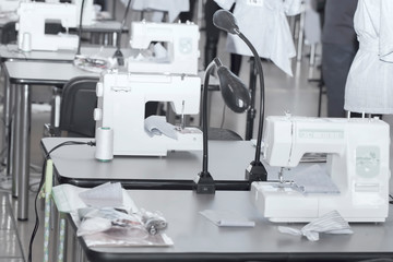 interior of garment factory shop. Closes making atelier with several sewing machines. Tailoring industry.