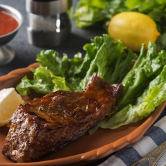 Grilled sturgeon on a plate with lemon. Sturgeon on a grill. Closeup