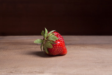 Strawberry fresh ripe sweet berry on wooden background.