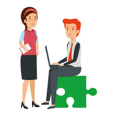 business couple sitting in puzzle piece with laptop