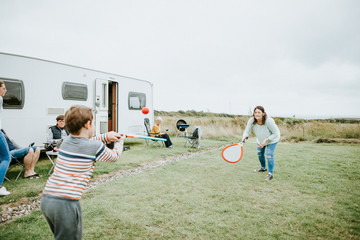 Mother and son playing beach tennis