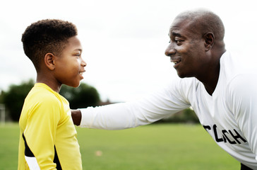 Football coach advising the goalkeeper