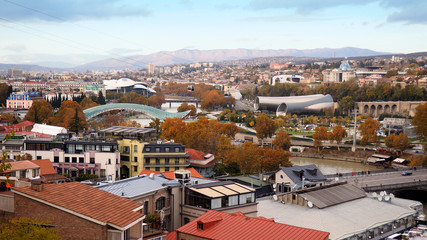 Panoramic view of Tbilisi, the capital of Georgia with old town and modern architecture at autumn. Bridge of peace, Kura river, presidential Palace and musical theatre. © Алексей Боев
