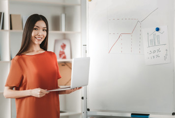 Dark-haired economist preparing monthly statistics
