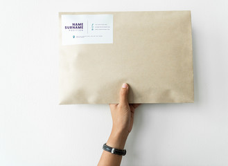 Woman holding up a package mockup