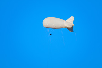 airship flies in the blue sky, add your advertisement