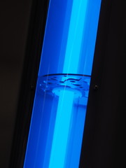 Blue UV light source in an industrial pipe arrangement - 235647428