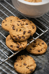 Chocolate chip cookies on dark background. Choco cookie black slate board.