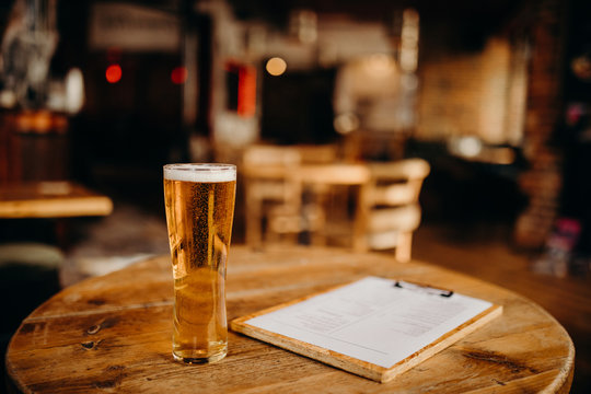 A Pint Of Beer On A Wooden Table At The Irish Pub.