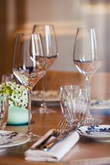 Table setting in a French restaurant. View through a window from a street.
