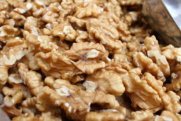 Full frame of peeled raw organic walnuts. Walnut background texture. Close up of nuts pattern. Walnuts wallpaper. Ripe and peeled walnut kernels