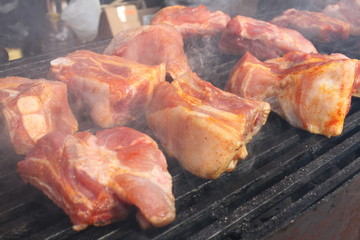 Pork brisket on barbeque. Ribs roasted on a bbq. Grilled meat on a sunlight, background wallpaper. Restaurant and food concept. Menu cover photo. Barbecued and marinated sticky spare ribs, copy space.