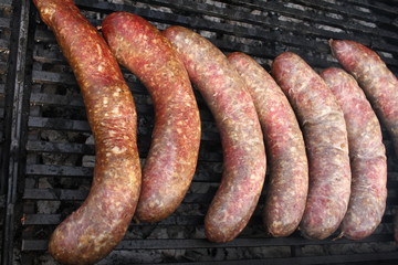 Raw stuffed sausages on a grill