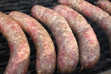 Fototapeta premium Raw stuffed sausages on a grill