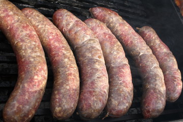 Raw stuffed sausages on a grill