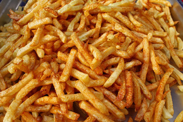 Tasty french fries full frame photo. Fat oiled French fries. Diet killing fried potatoes. Pile of fried potatoes. Potato chips background patter. French fries wallpaper. USA fast food concept.