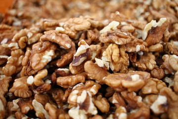 Full frame of peeled raw organic walnuts. Walnut background texture. Close up of nuts pattern. Walnuts wallpaper. Ripe and peeled walnut kernels