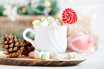 Merry Christmas and happy New year. Cup of cocoa and marshmallows on a light background. Background with copy space. Selective focus. Christmas background.