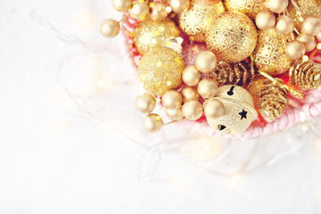 Merry Christmas and happy New year. Golden Christmas toys on a light background. Selective focus. Top view. Christmas background. Background with copy space.