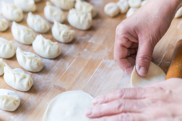 Fototapeta na wymiar Manufacturing process of wrapped dumpling rolled dumpling skin