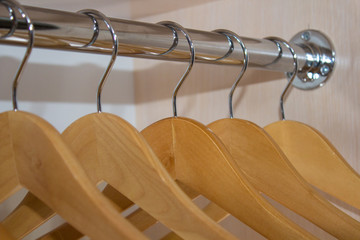 wooden hangers in the closet,Many wooden hangers on a rod, empty wardrobe