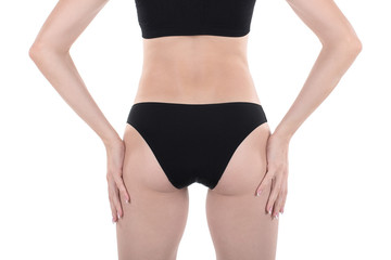 Female well groomed cropped fit buttocks and back in base black underwear, isolated on white.