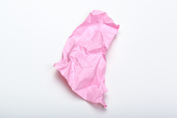 close up of a crumpled paper with curled edge on white background