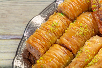 Delicious baklava dessert in oriental bronze setting close up