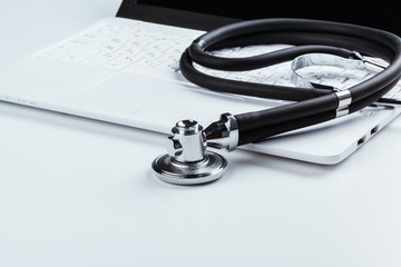 Stethoscope With Laptop on the table